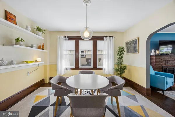 a dining room with furniture a chandelier and window