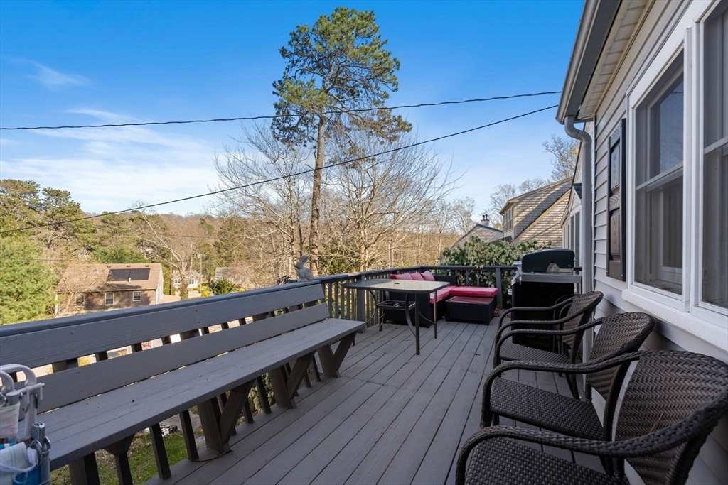 11 W Road Sandwich, MA 02644 - Photo 12 of 42 a view of a balcony with furniture and a grill