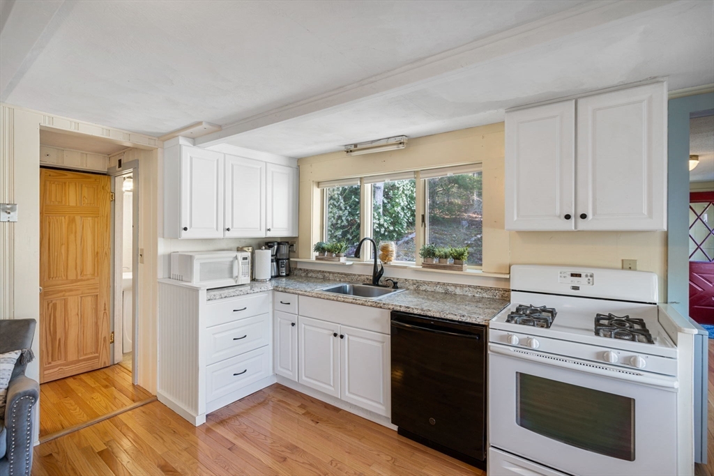 11 W Road Sandwich, MA 02644 - Photo 17 of 42 a kitchen with a stove a sink and a window