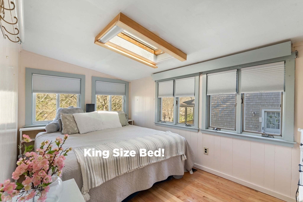 11 W Road Sandwich, MA 02644 - Photo 26 of 42 a bedroom with a large bed and a large window
