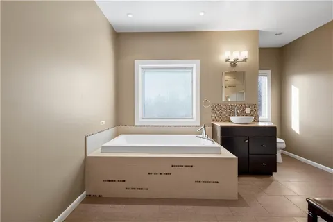 a spacious bathroom with a sink and a mirror