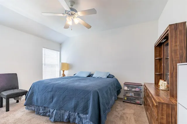 a bedroom with a bed dresser and a window