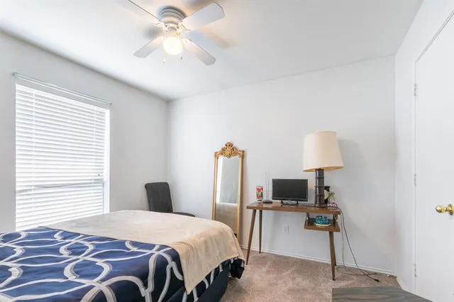 a bedroom with a bed and a lamp