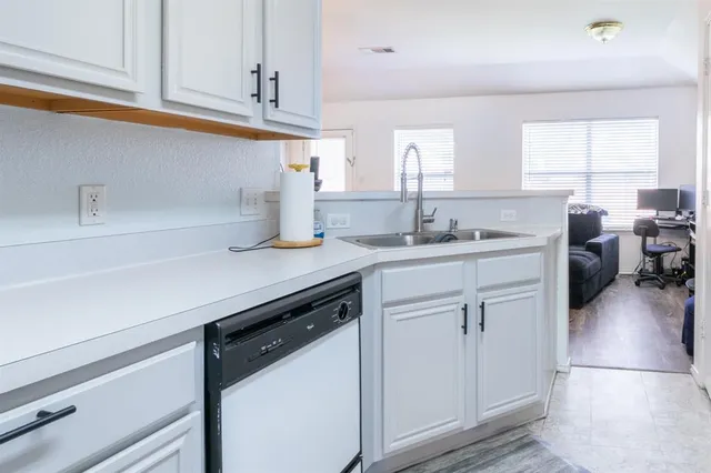 a kitchen with a sink cabinets and appliances