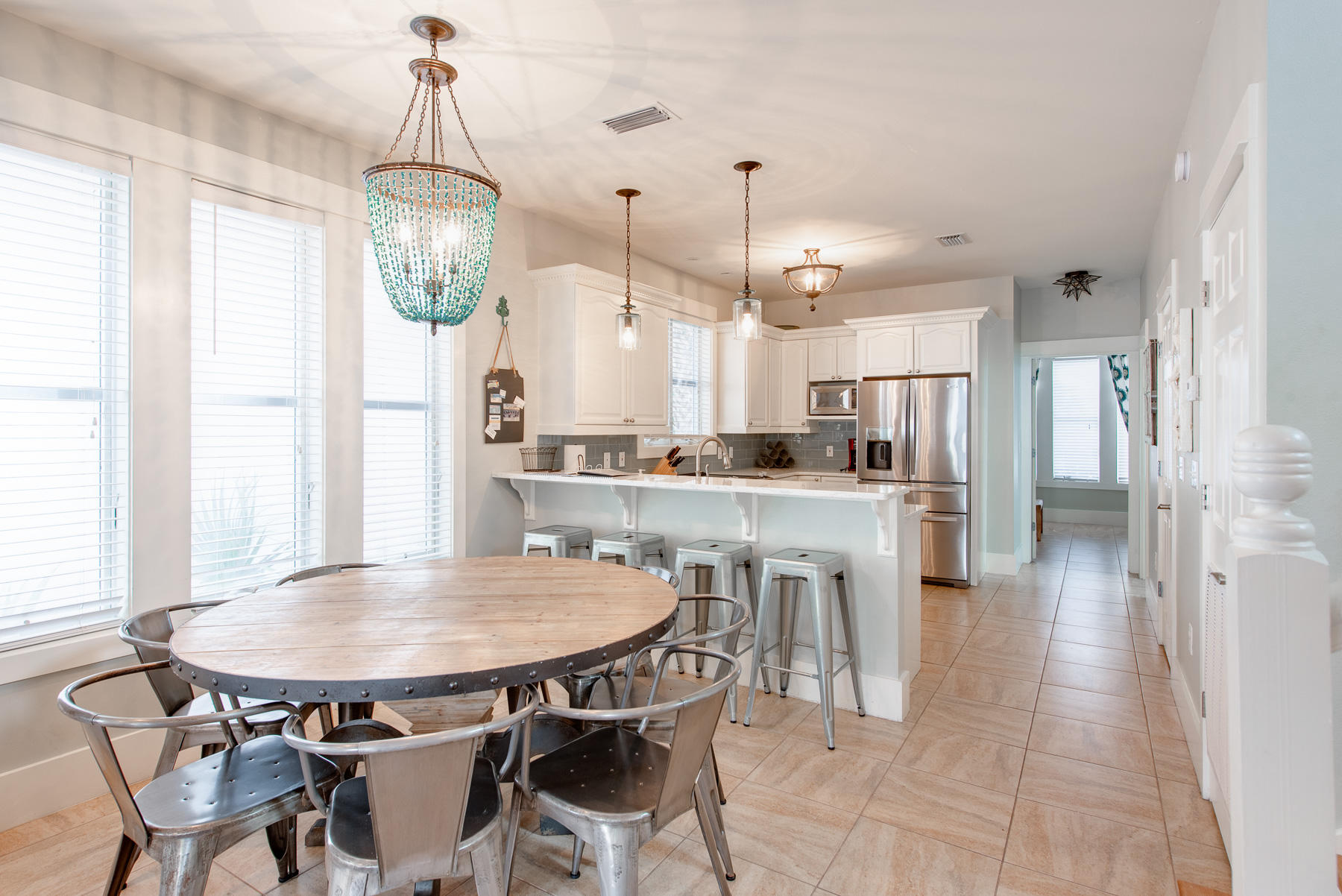 3 West Trigger Trail Inlet Beach Inlet Beach, FL 32461 - Photo 8 of 44 a kitchen with stainless steel appliances kitchen island granite countertop a table chairs and a chandelier