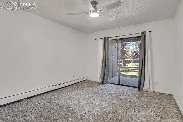 a view of a room with a fan & a window
