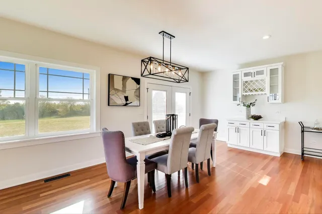 a view of a dining room with furniture window and wooden floor