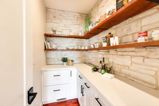 a kitchen with a sink a stove and cabinets