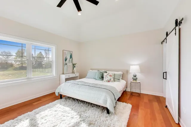 a bedroom with a bed and window
