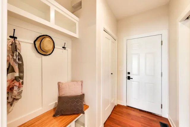 a view of a room with wooden floor and glass windows