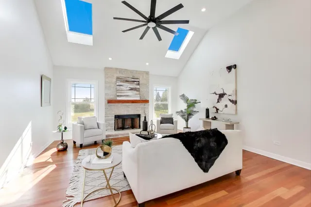 a living room with furniture a fireplace and a chandelier