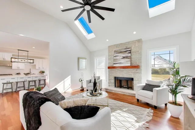 a living room with furniture fireplace and dining table