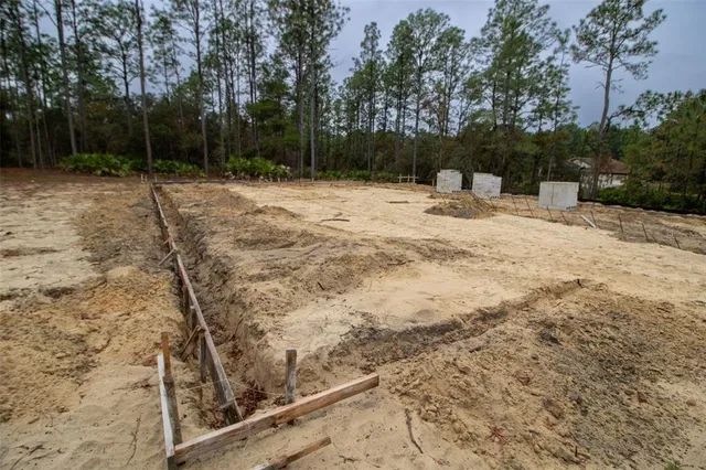 a swimming pool with trees in the background