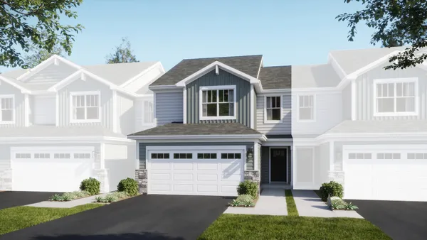 a front view of a house with a yard and potted plants