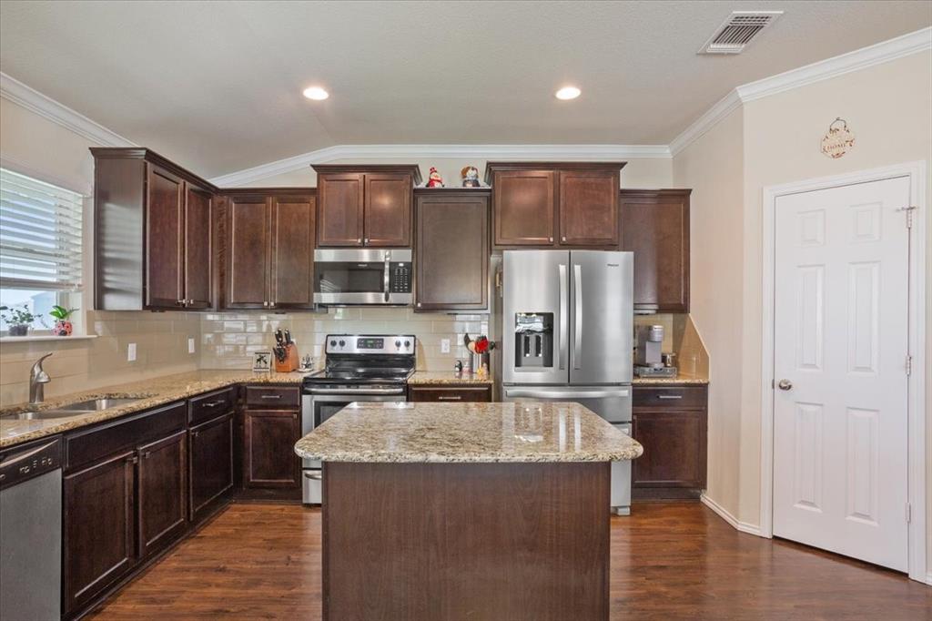 5308 Tama Drive Waco, TX 76708 - Photo 13 of 29 a kitchen with stainless steel appliances granite countertop a sink stove and refrigerator