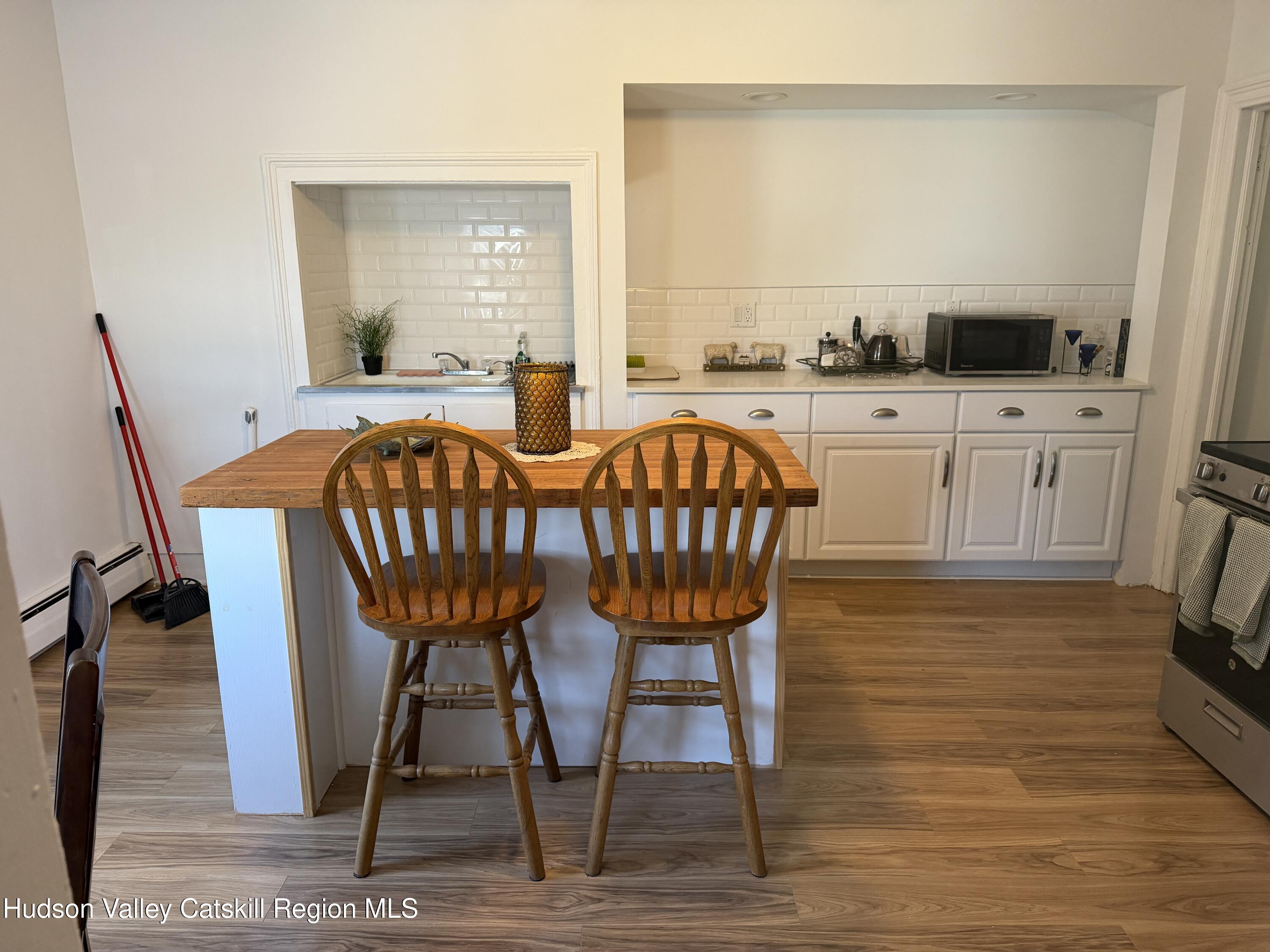 129 Main Street, Unit 3 Philmont, NY 12529 - Photo 2 of 8 a view of a dining room with furniture and wooden floor