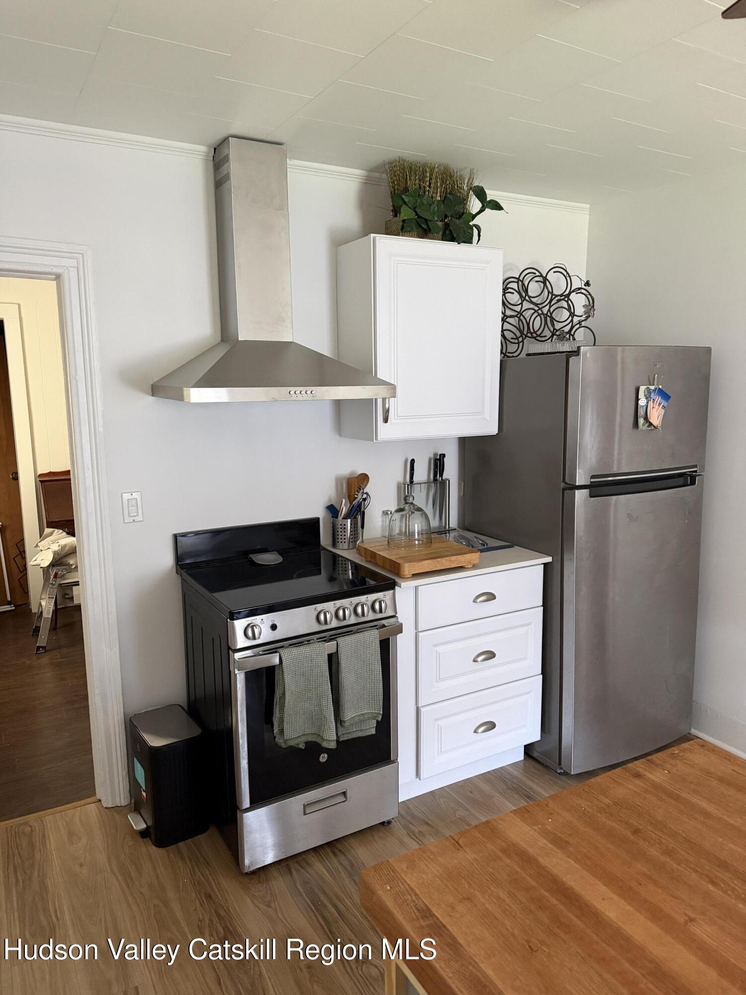 129 Main Street, Unit 3 Philmont, NY 12529 - Photo 3 of 8 a kitchen with stainless steel appliances a stove a refrigerator and cabinets