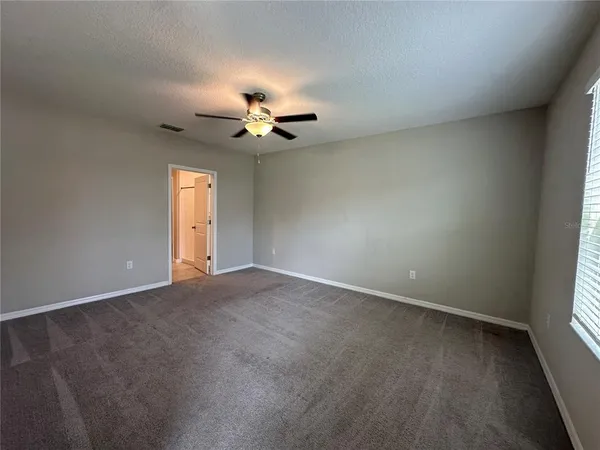 an empty room with a empty space and a ceiling fan