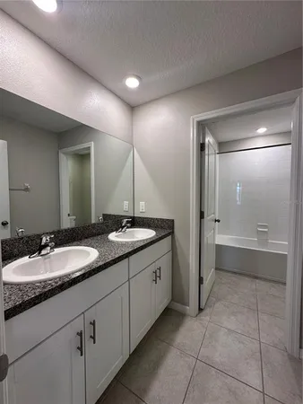a bathroom with a toilet a sink and bathtub