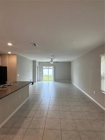 a view of a kitchen with a sink and a window