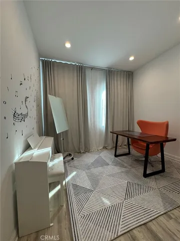 a spacious bedroom with a bed and a desk