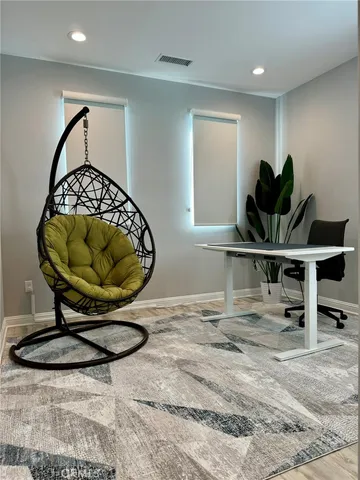 an empty room with entrance and wooden floor