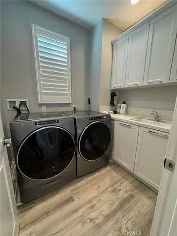 a spacious bedroom with a bed and a night stand