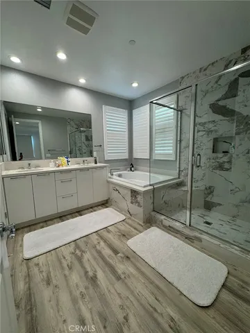 a bathroom with a shower sink and mirror