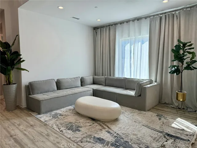 a living room with furniture and a potted plant