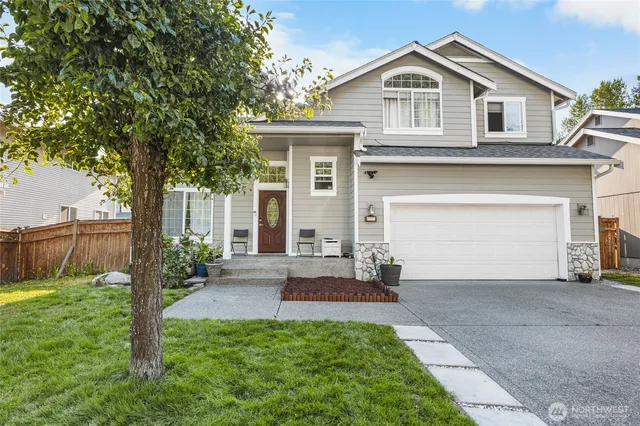 a front view of a house with a yard and garage