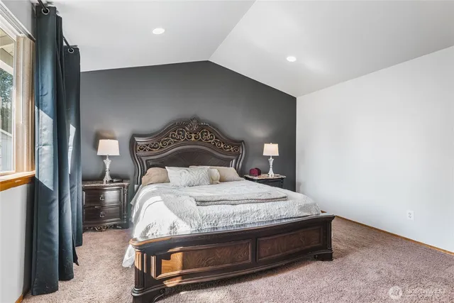 a en suite bathroom with a double vanity sink and a mirror