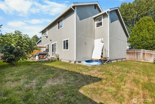 a view of a patio with table and chairs with wooden fence and plants