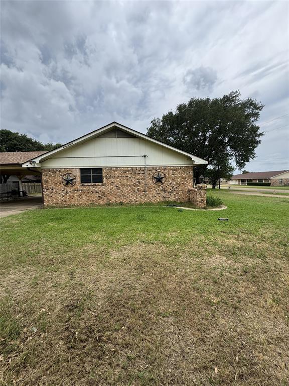 636 East Kempner Street Mabank, TX 75147 - Photo 7 of 28 Brick facade dwelling with a gabled roofline and a mature tree