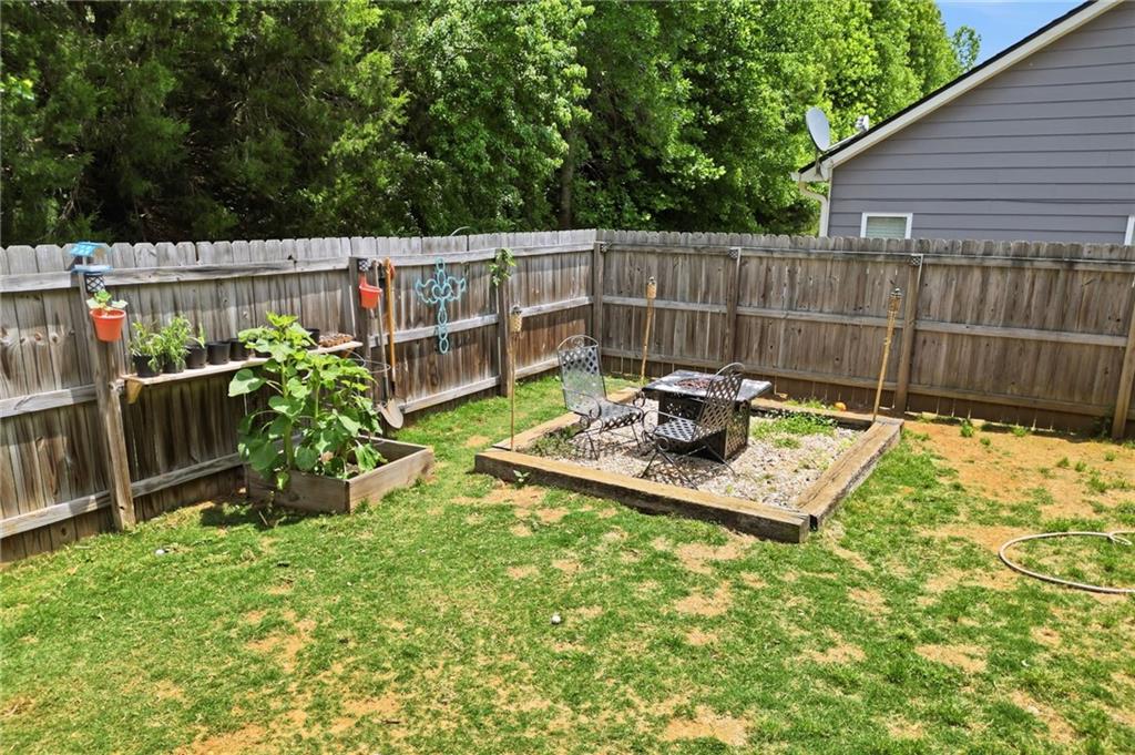 123 Renford Road Ball Ground, GA 30107 - Photo 23 of 27 a view of a backyard with a wooden fence