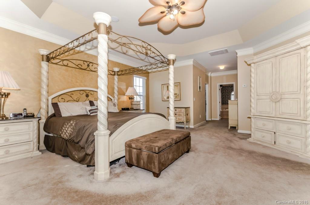 1982 Faison Avenue Fort Mill, SC 29708 - Photo 15 of 24 a spacious bedroom with a bed mirror and couch