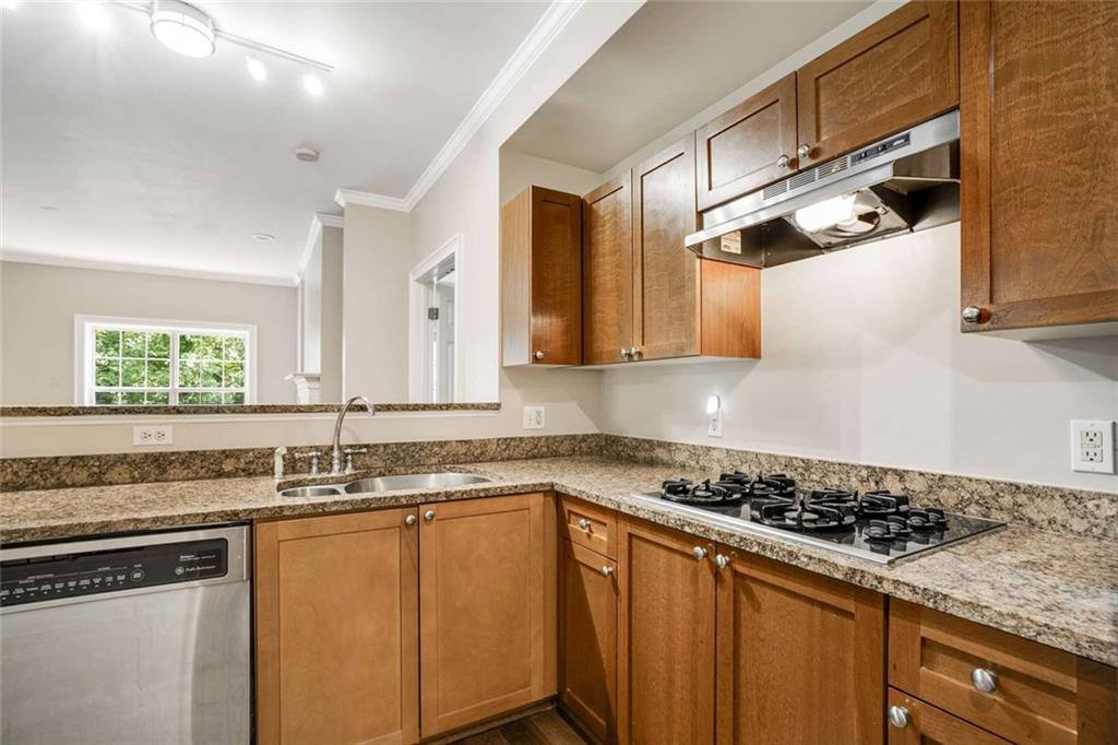 3275 Lenox Road Northeast, Unit 302 Atlanta, GA 30324 - Photo 11 of 50 a kitchen with stainless steel appliances granite countertop a sink a stove and oven