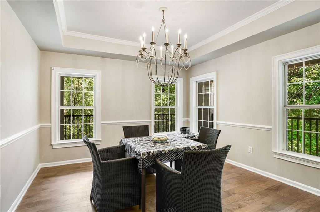 3275 Lenox Road Northeast, Unit 302 Atlanta, GA 30324 - Photo 13 of 50 a dining room with furniture a chandelier and window