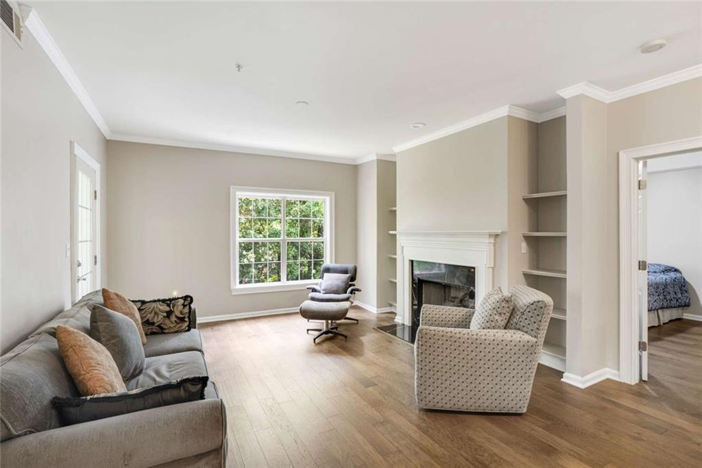 3275 Lenox Road Northeast, Unit 302 Atlanta, GA 30324 - Photo 15 of 50 a living room with furniture fireplace and a large window