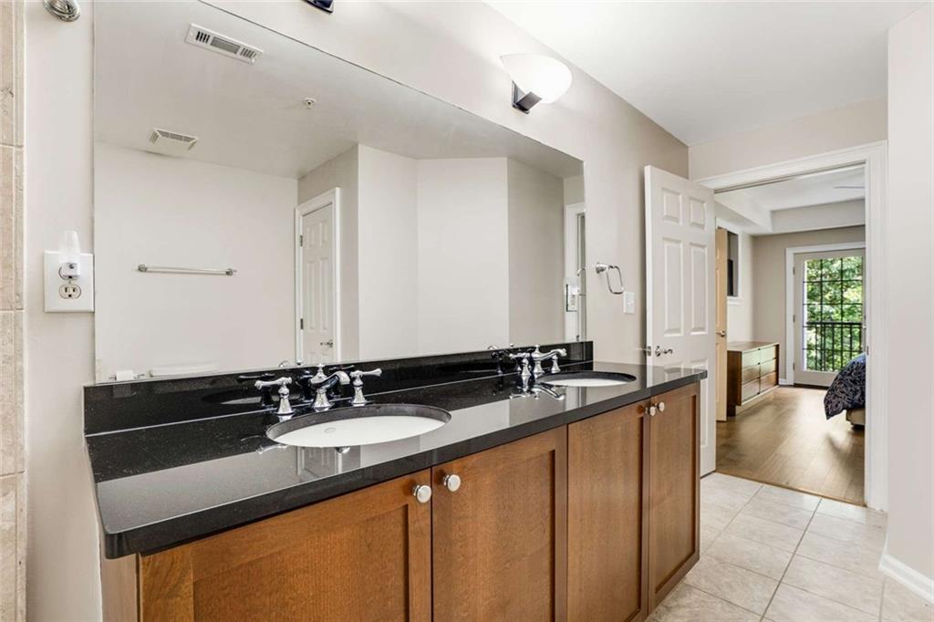 3275 Lenox Road Northeast, Unit 302 Atlanta, GA 30324 - Photo 22 of 50 a en suite bathroom with a sink and a mirror