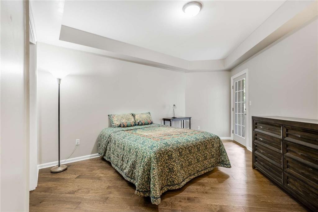 3275 Lenox Road Northeast, Unit 302 Atlanta, GA 30324 - Photo 25 of 50 a bedroom with a bed and cabinets