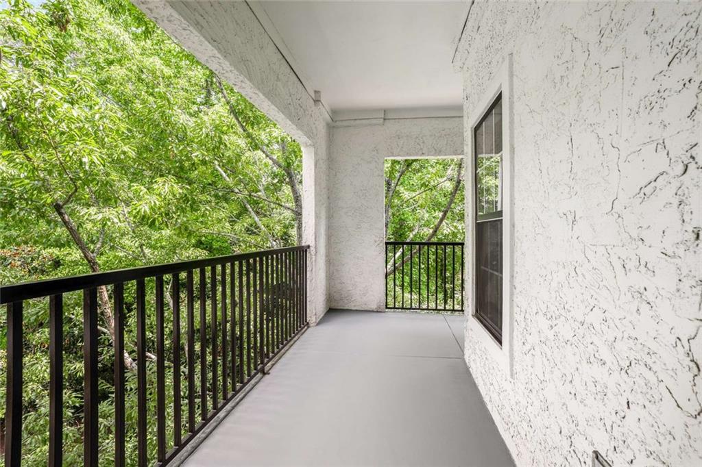3275 Lenox Road Northeast, Unit 302 Atlanta, GA 30324 - Photo 33 of 50 a view of a porch with wooden floor and fence