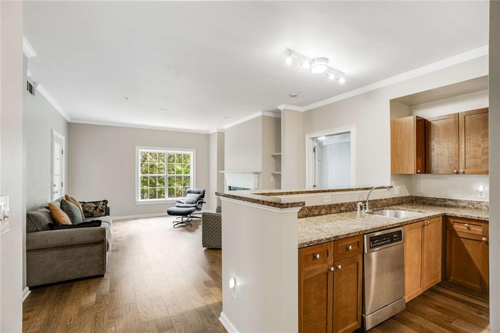 3275 Lenox Road Northeast, Unit 302 Atlanta, GA 30324 - Photo 7 of 50 a view of a kitchen counter space with wooden floor and furniture