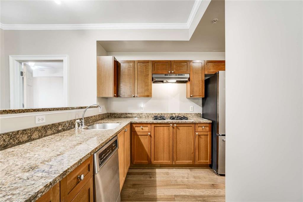 3275 Lenox Road Northeast, Unit 302 Atlanta, GA 30324 - Photo 8 of 50 a kitchen with granite countertop a sink and a stove