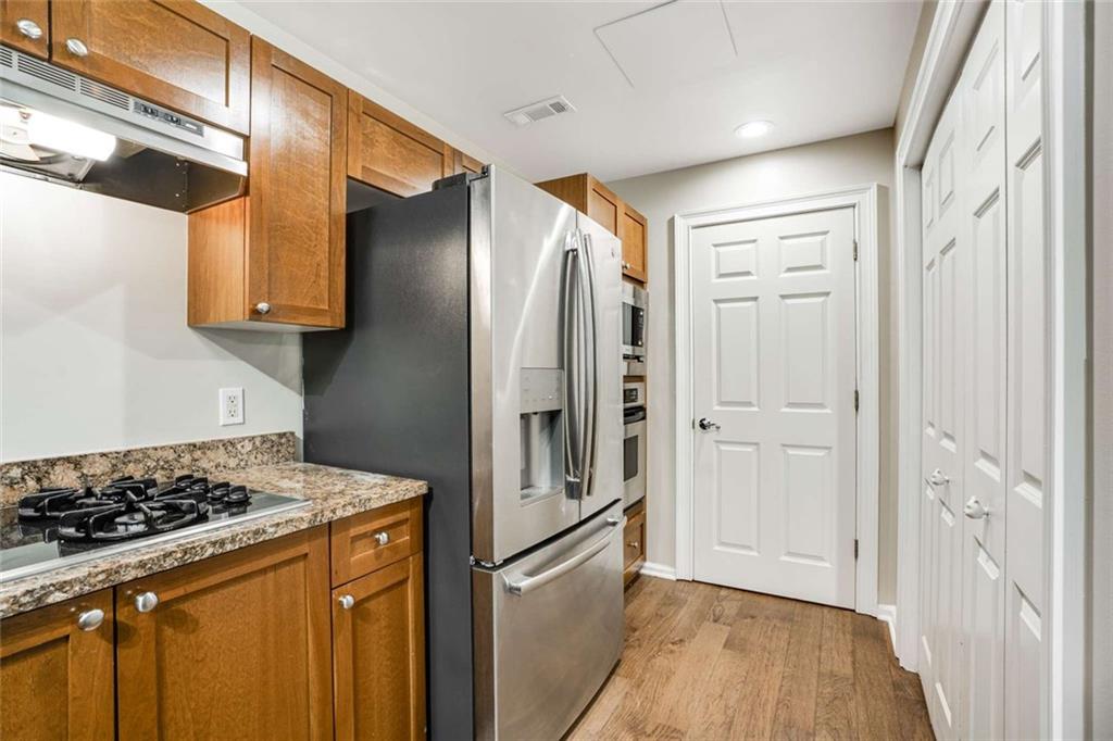 3275 Lenox Road Northeast, Unit 302 Atlanta, GA 30324 - Photo 10 of 50 a kitchen with stainless steel appliances granite countertop a refrigerator and a stove