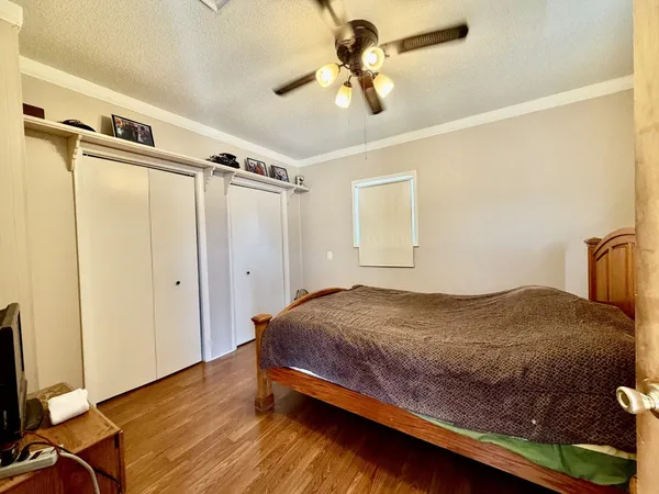 a bedroom with a bed and a chandelier
