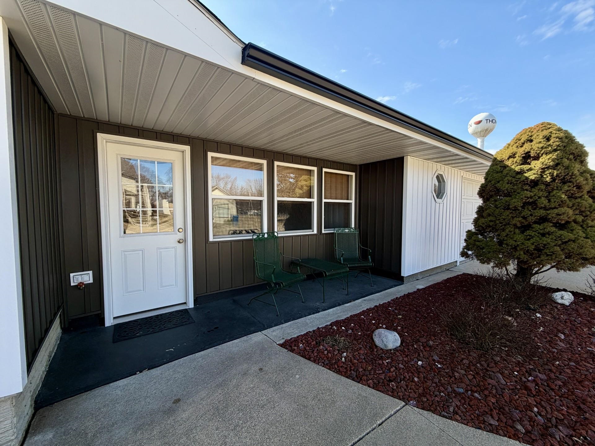 803 North Street Thomson, IL 61285 - Photo 2 of 26 a front view of a house with garden