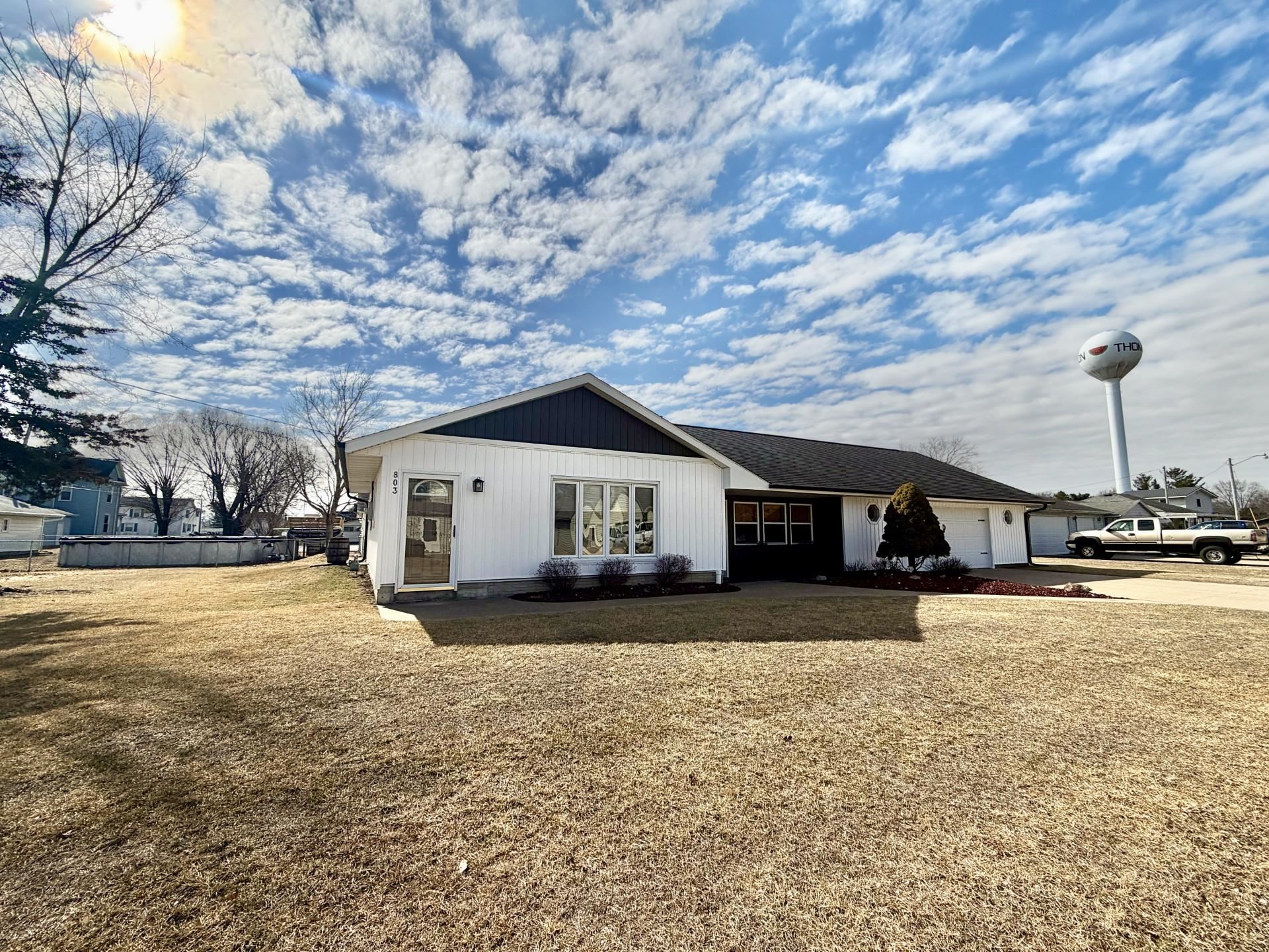 803 North Street Thomson, IL 61285 - Photo 23 of 26 a wooden house with a yard and large trees