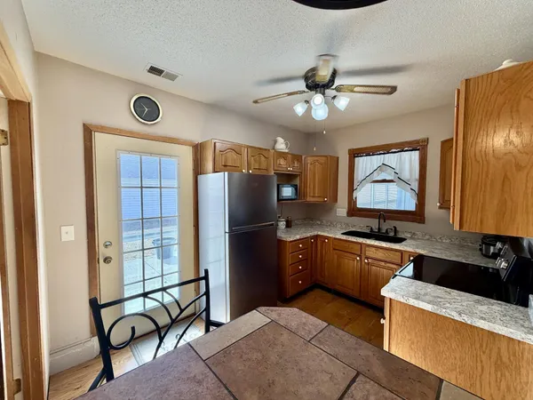 a kitchen with granite countertop cabinets and stainless steel appliances