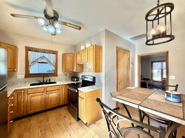a large kitchen with a table and chairs