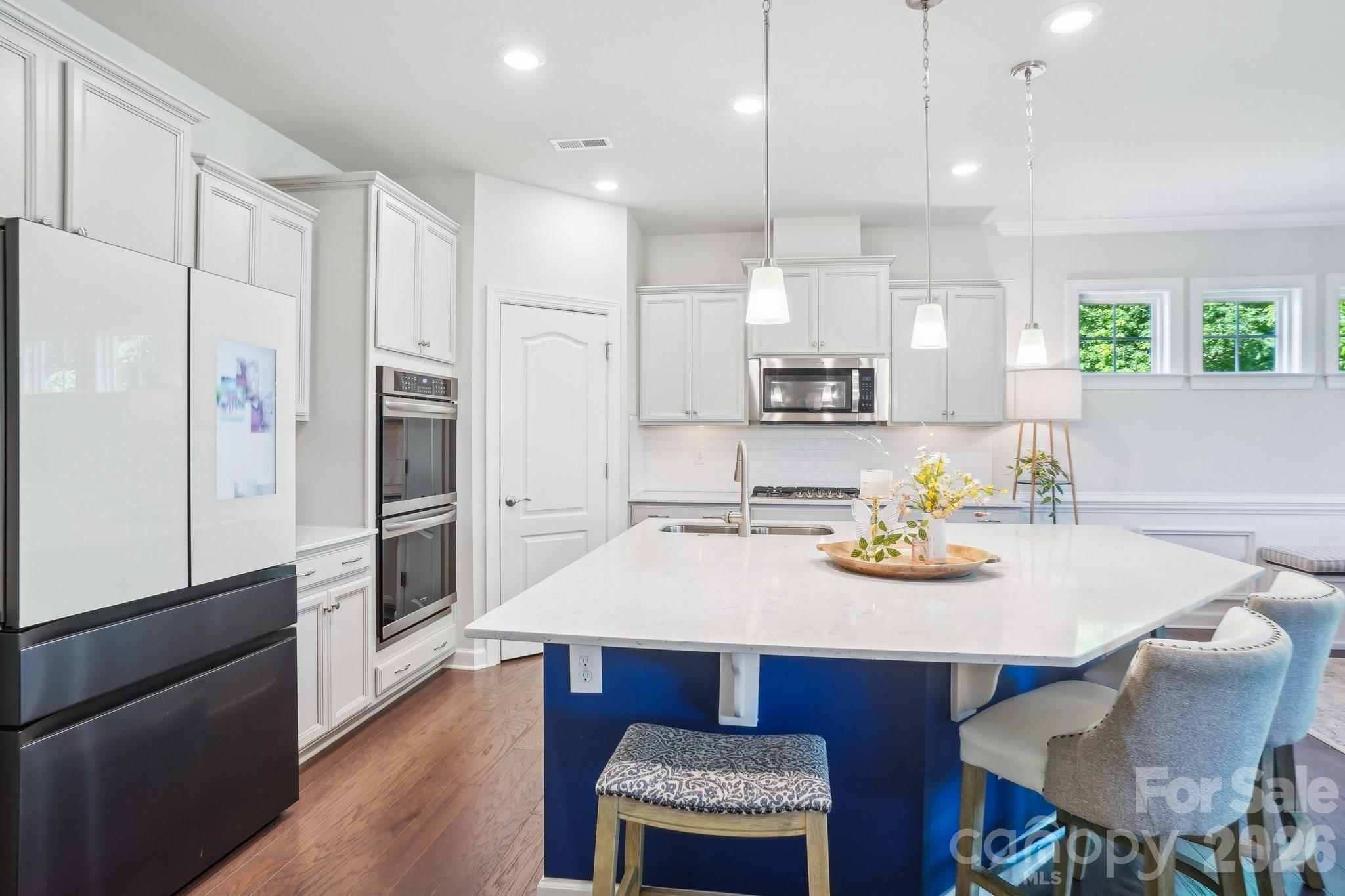 16427 Cozy Cove Road Charlotte, NC 28278 - Photo 11 of 47 a kitchen with refrigerator and chairs